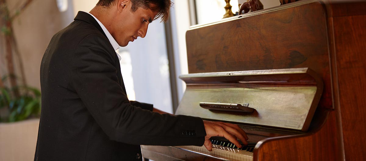 A man playing piano emotionally