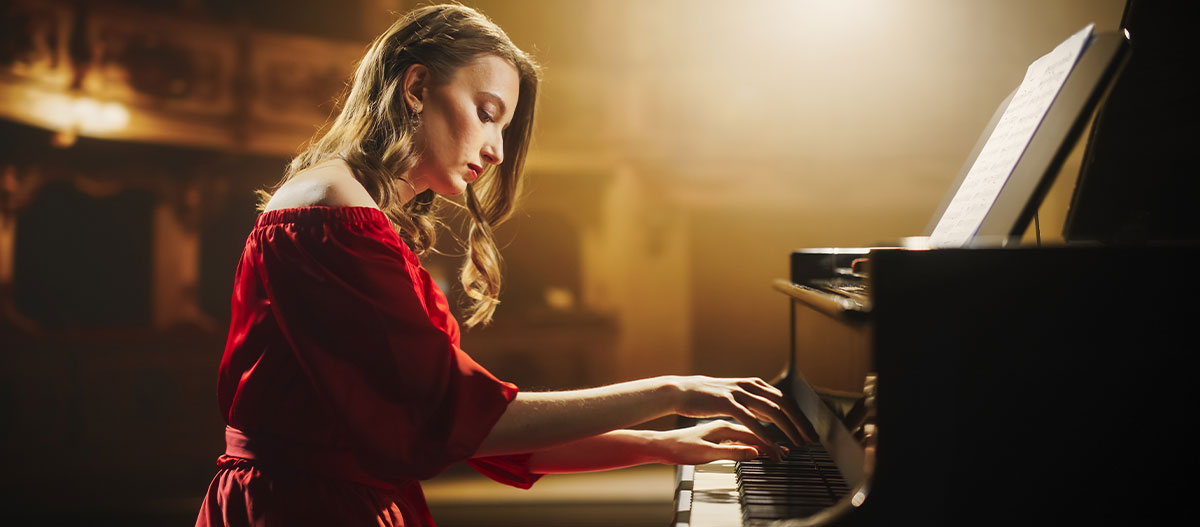 Beautiful lady pianist performing on stage