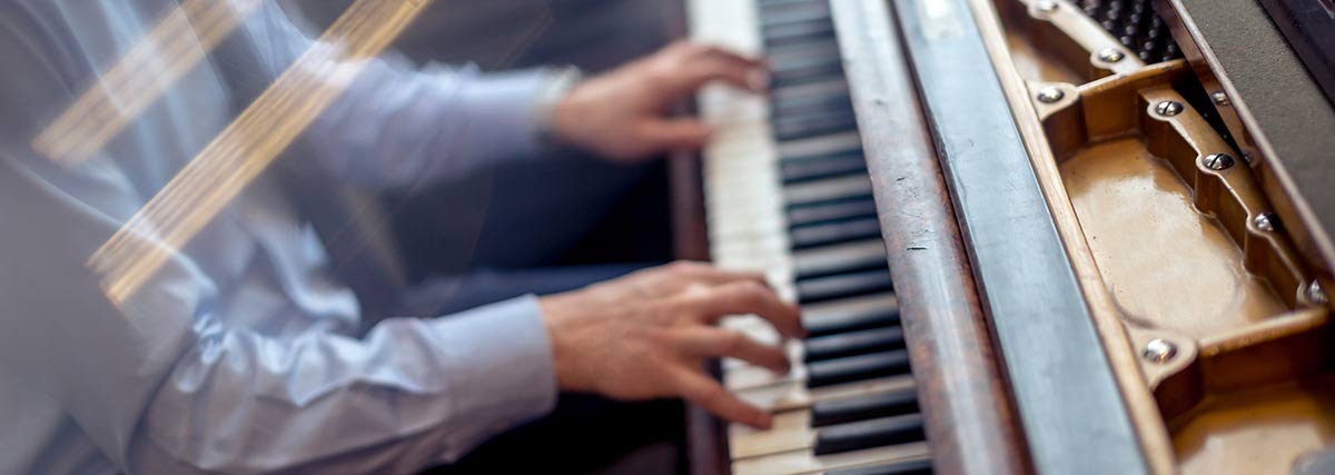 blurry man playing the piano