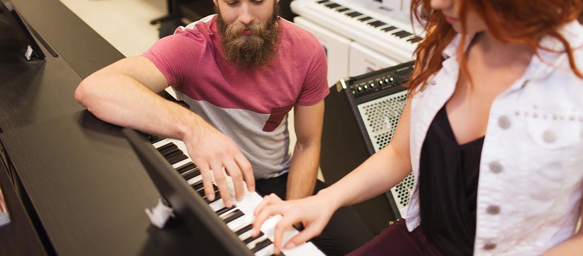 Couple playing piano together