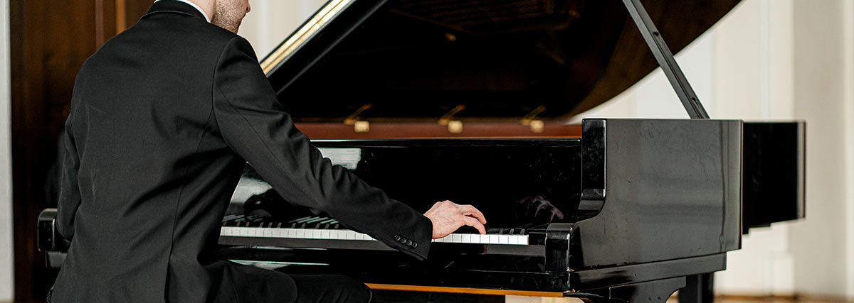 Cropped unrecognizable male playing piano