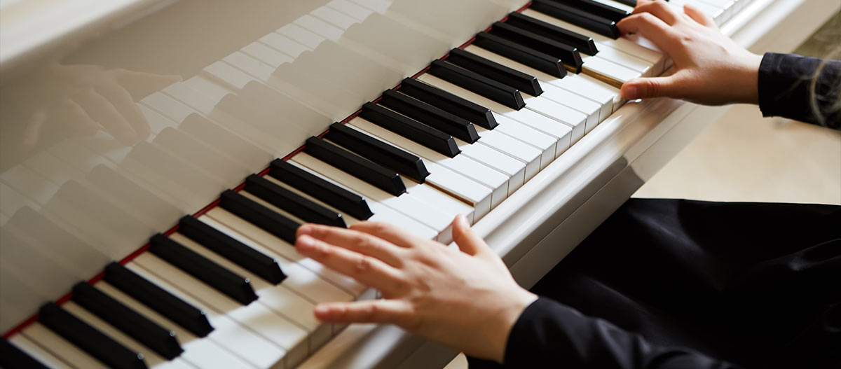 Female hands on the piano keyboard