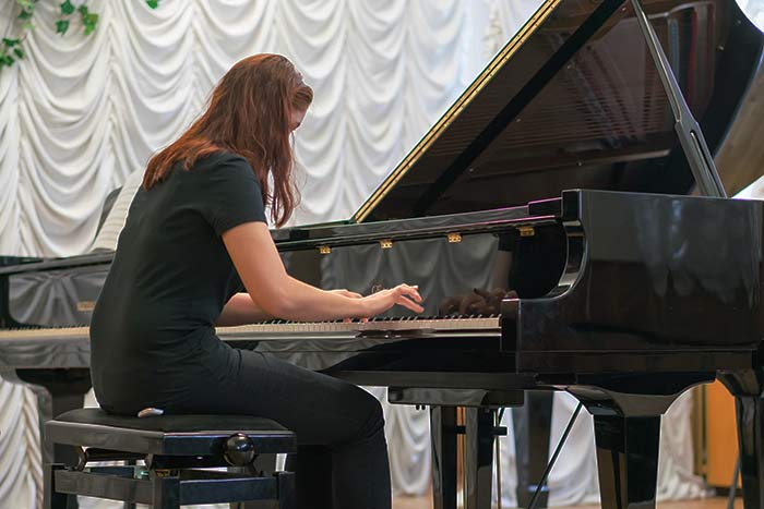 female pianist performing feat