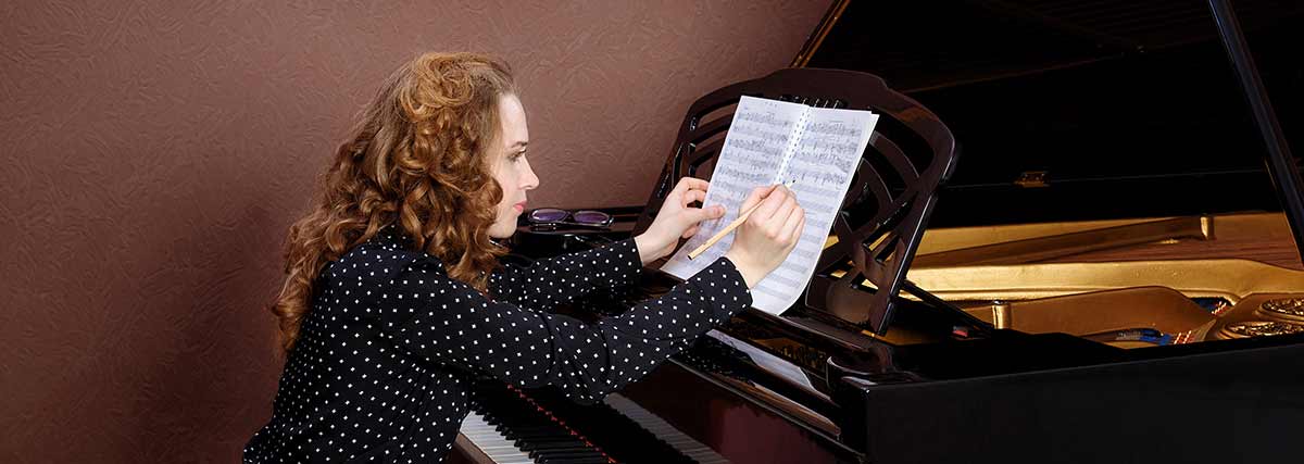 female pianist writing notes