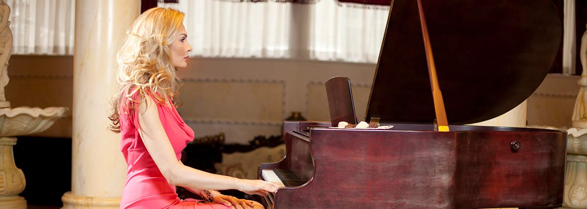 female playing the grand piano