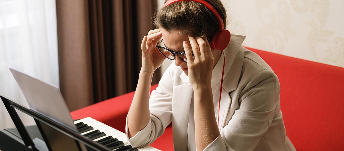 Frustrated woman with headset on and hands on her head