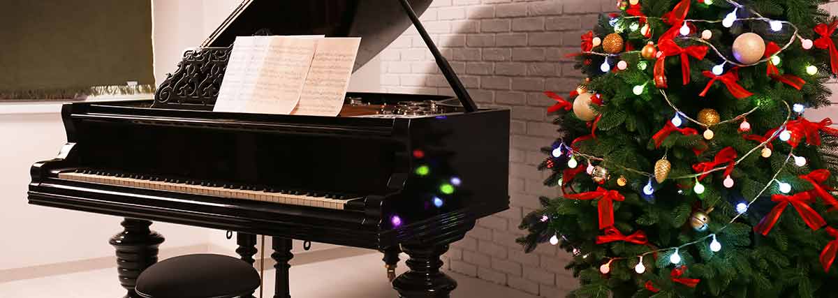 grand piano beside the Christmas tree