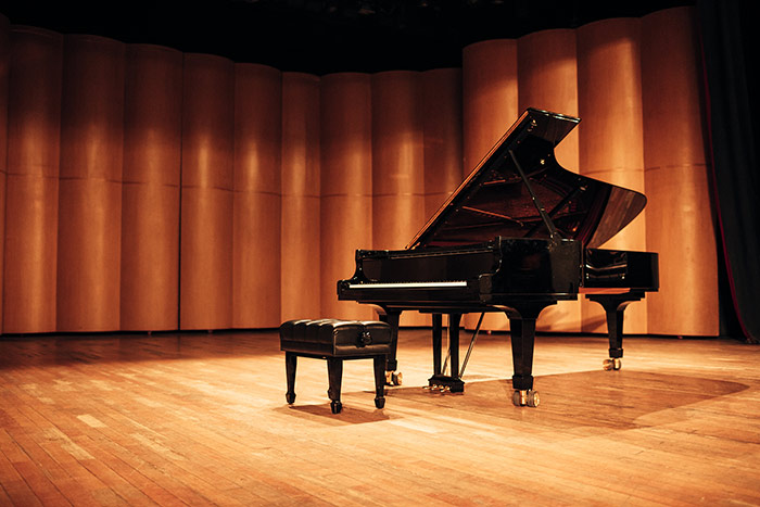 Grand piano in concert stage feat