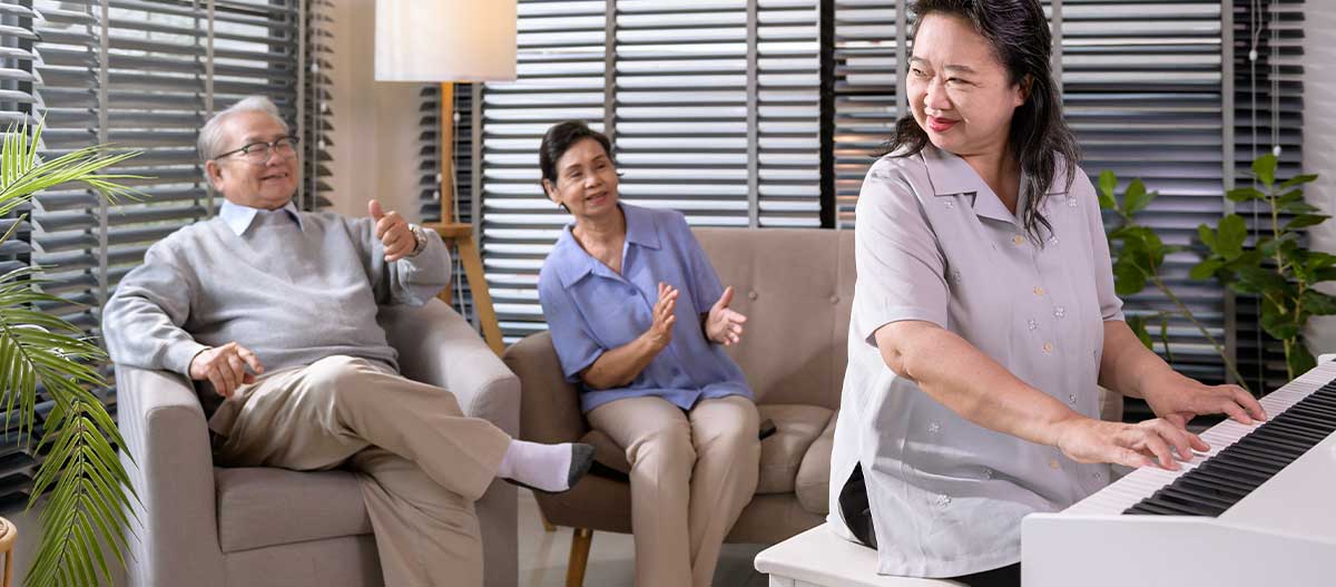 Group of Asian senior people playing piano and enjoying music