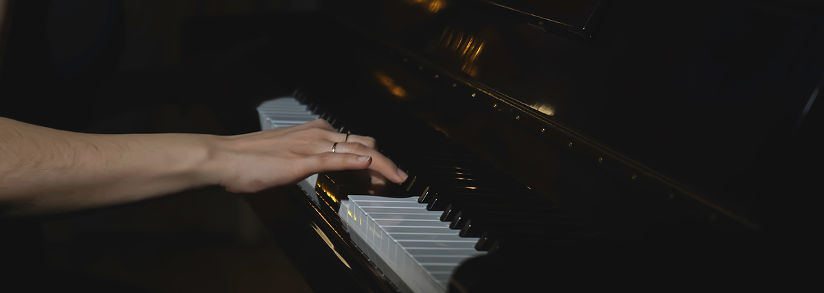 Hand on piano keyboard