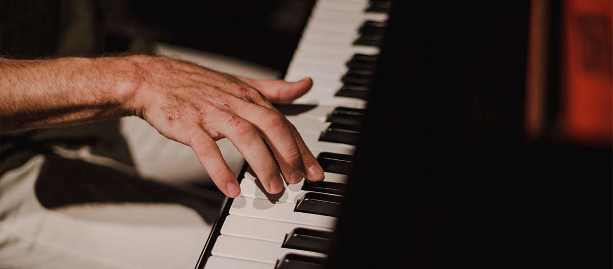 Hand pressing piano key