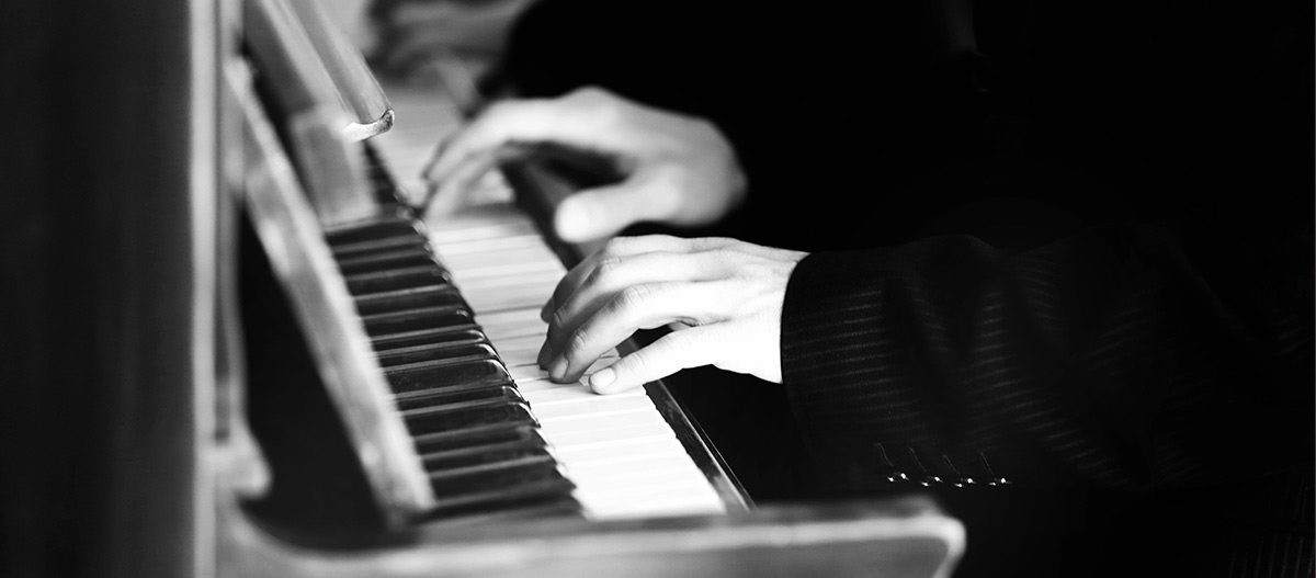 Hands of pianist on an old piano