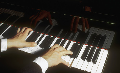 Hands on a grand piano