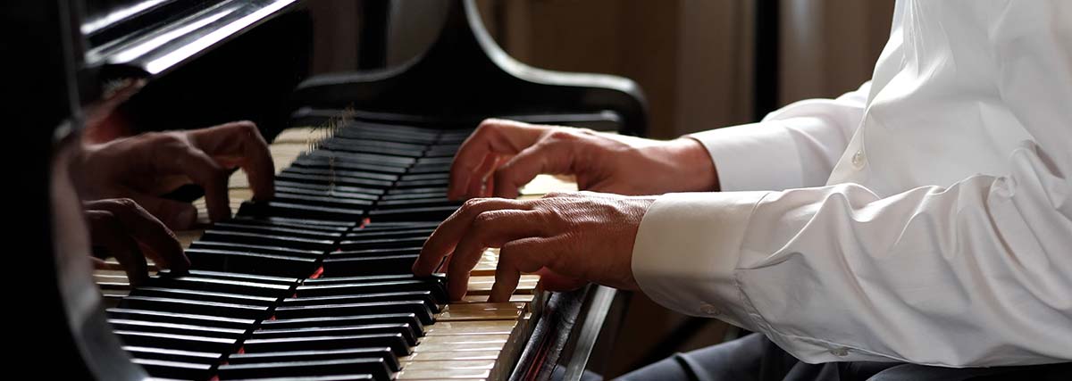 hands playing on the piano