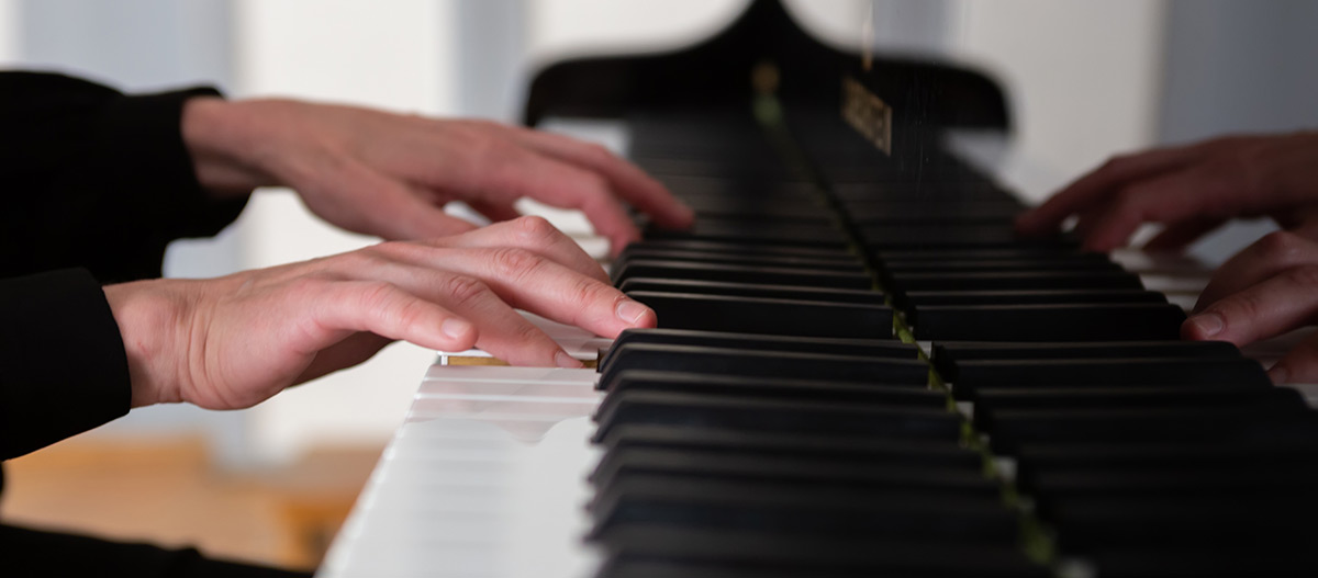 Hands playing piano