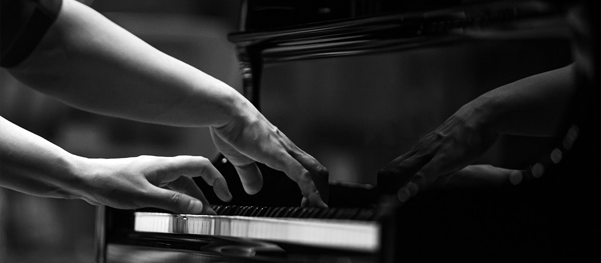 Hands playing piano black and white photo