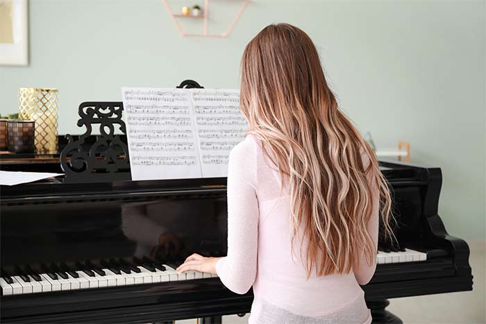 Lady playing a grand piano