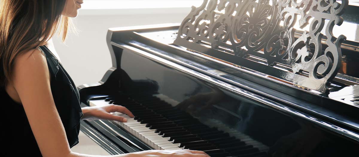 Lady playing grand piano