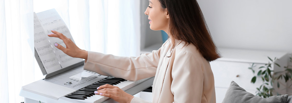 Lady practicing piano at home