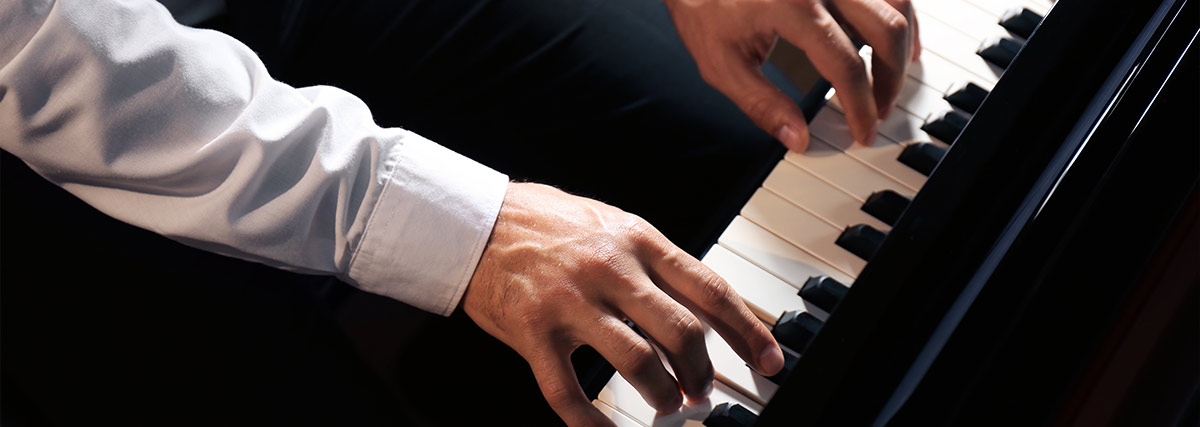 Male hands on the piano keyboard