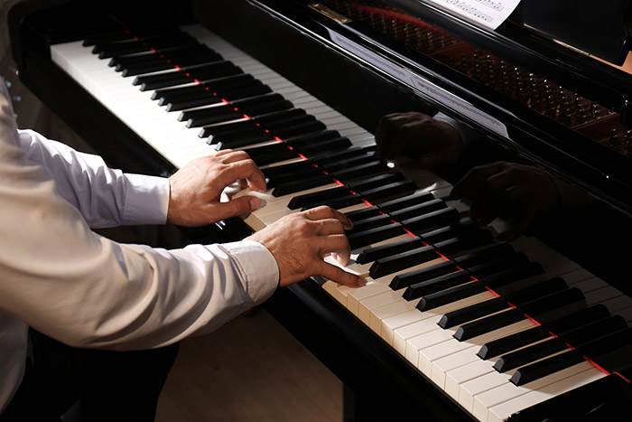 Male hands on the piano keyboard