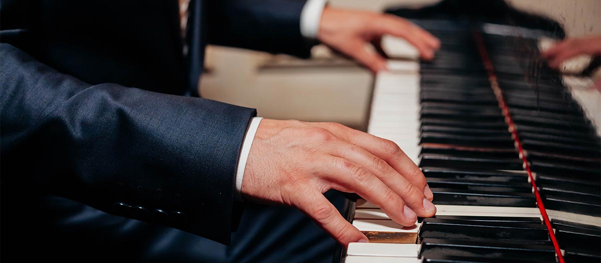 Male hands playing the piano