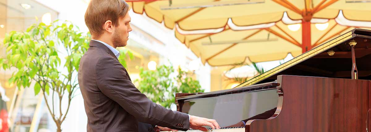 male pianist playing the piano