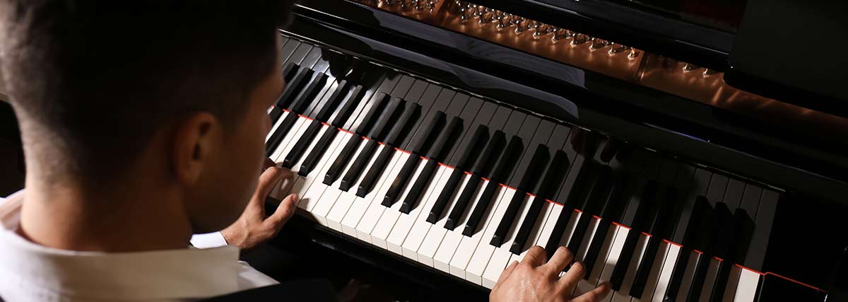 male pianist playing