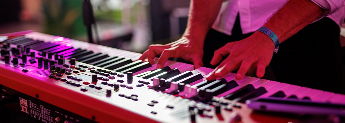 Man hands playing electric keyboard