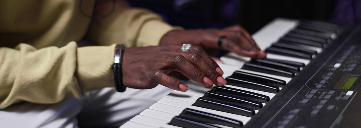 Man hands playing piano