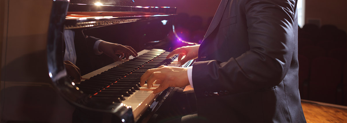 Man hands playing piano