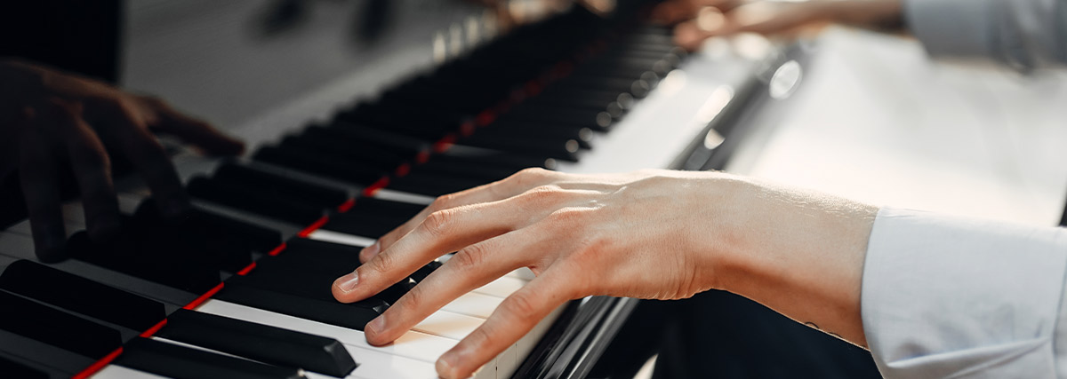 Man hands playing piano