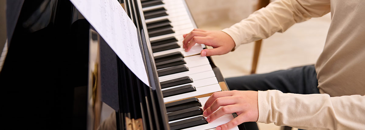 Man hands playing piano
