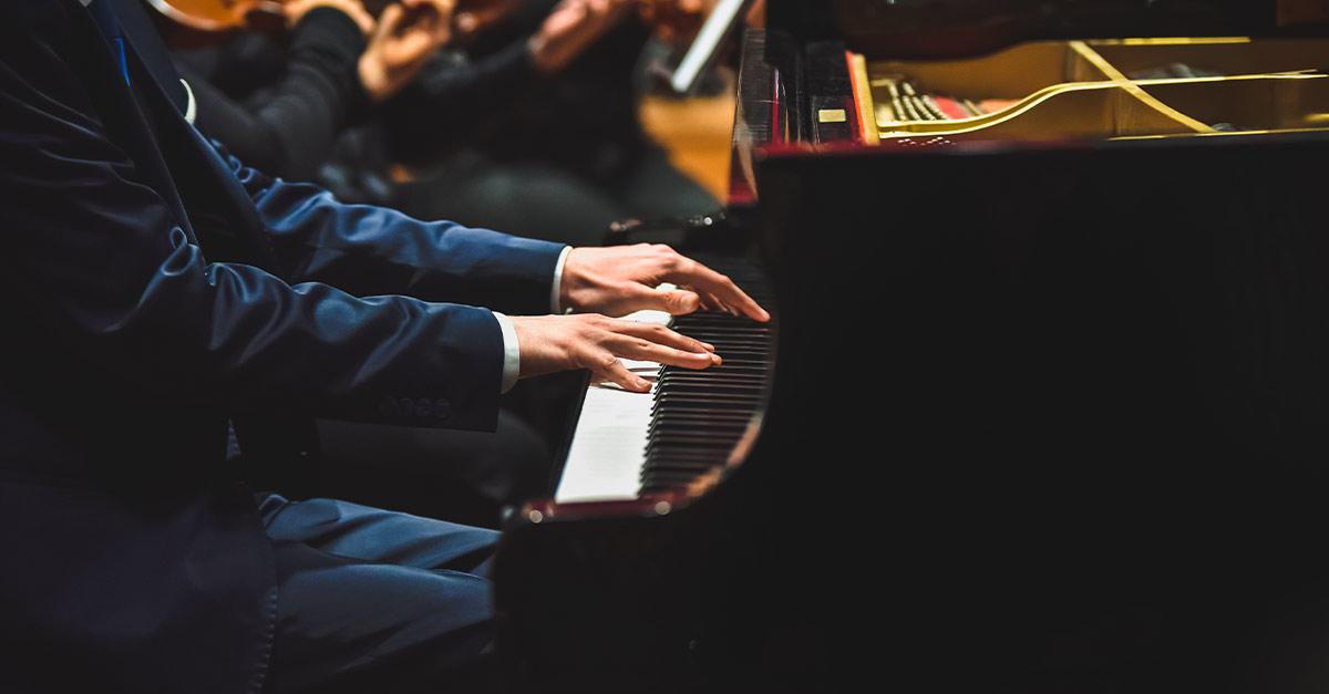 Man in suit playing piano