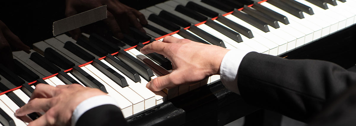 Man in suit playing piano