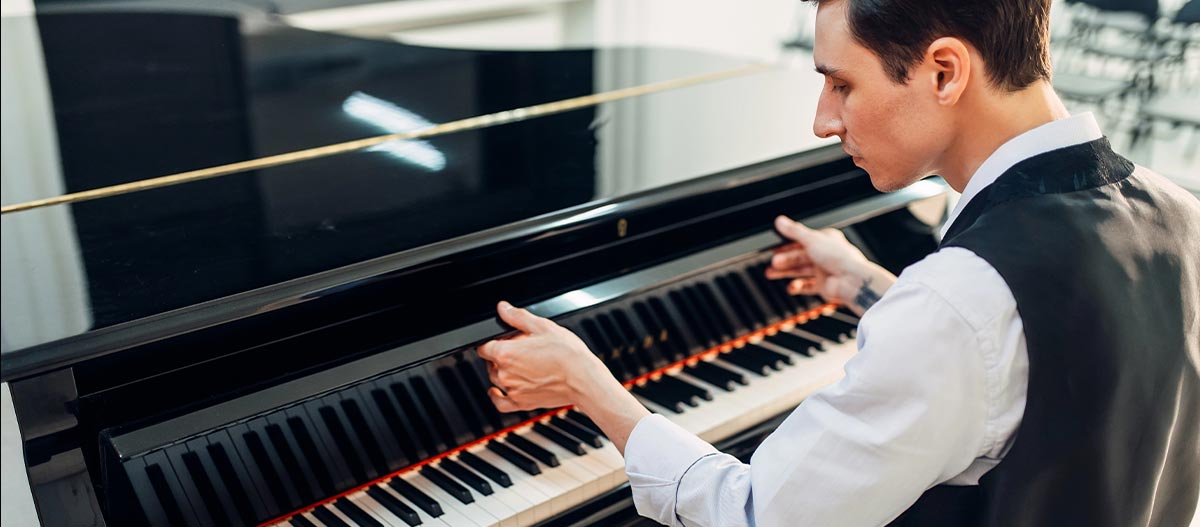 Man lifting the piano cover