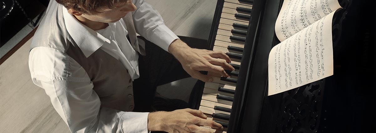 Man on vest playing the piano