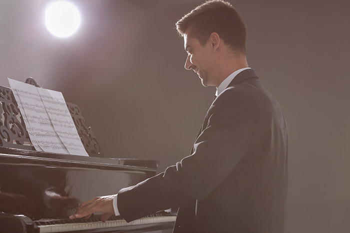 man performing on the piano feat
