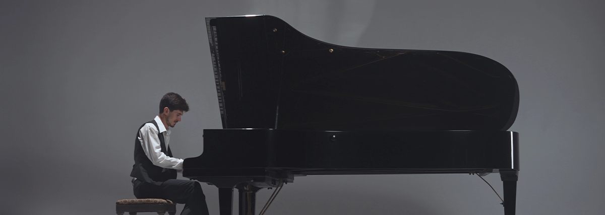 Man performing with grand piano