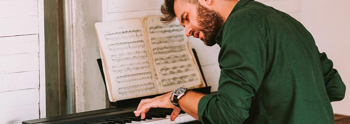 Man playing electric piano at home