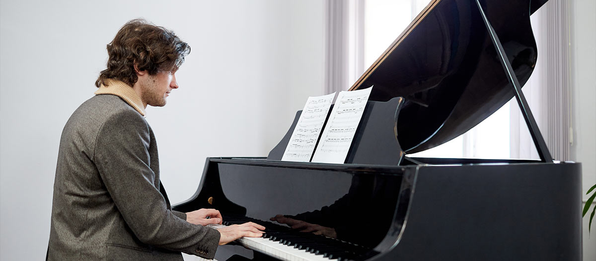 Man playing grand piano
