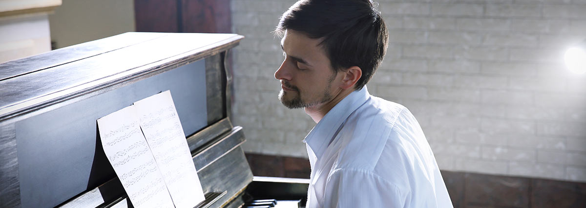 A man playing piano emotionally 