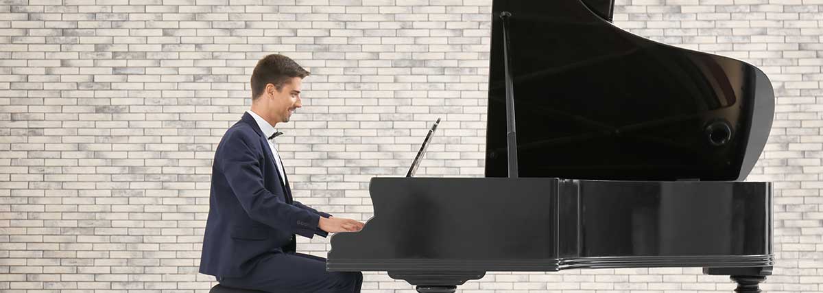 man playing the grand piano