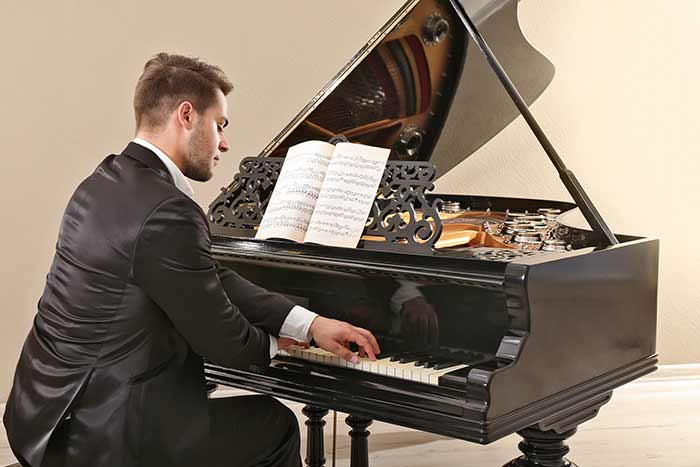 man playing the grand piano feat
