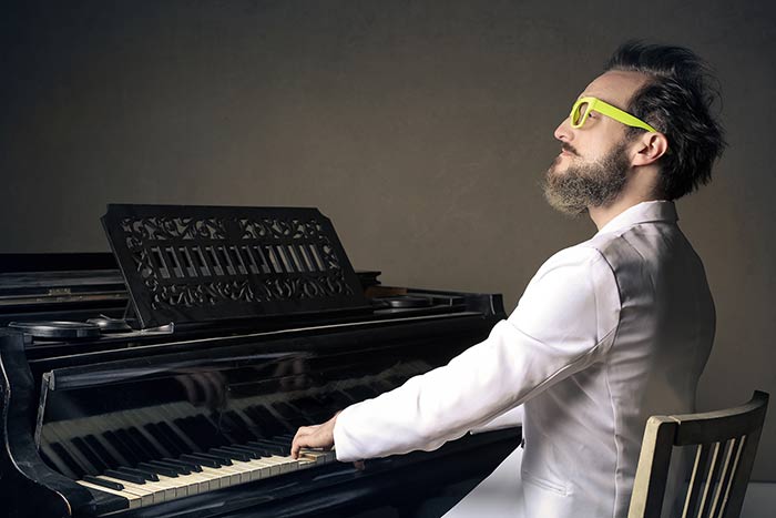man playing the piano feat