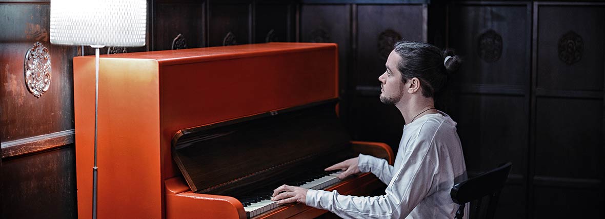 man playing the piano in a room
