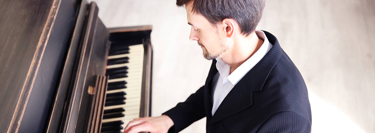 man practising the piano