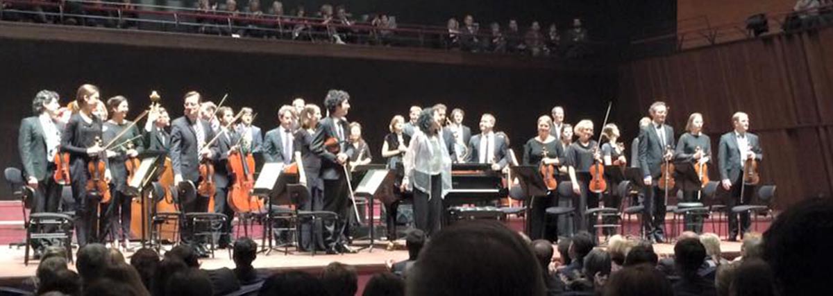 Mitsuko Uchida performing on stage with orchestra