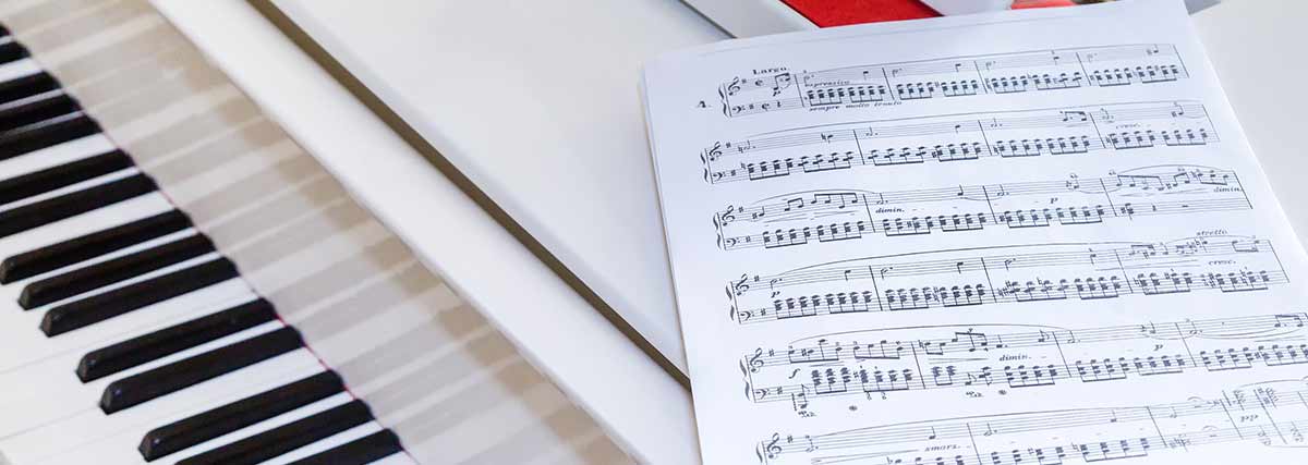 music sheet on top of the grand piano