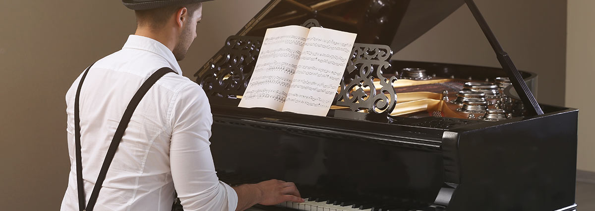 Man playing on a stunning grand piano